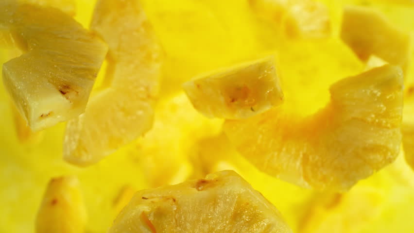 Super Slow Motion Shot of Flying Fresh Pineapple Slices at 1000 fps.