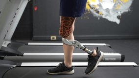 Modern Hospital Physical Therapy: Patient with Injury Walks on Treadmill Wearing Advanced Robotic Bionic Legs. Physiotherapy Rehabilitation Technology to Make Disabled Person Walk. Focus on Legs - Powered by Shutterstock - Get 15% off with code: PIKWIZARD15