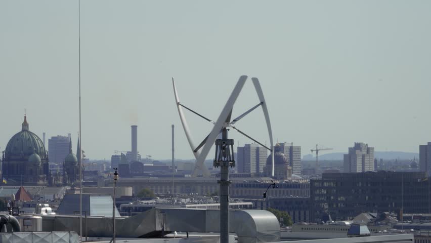 Vertical-axis wind turbine generating renewable energy on a rooftop  Royalty-Free Stock Footage #1109377319