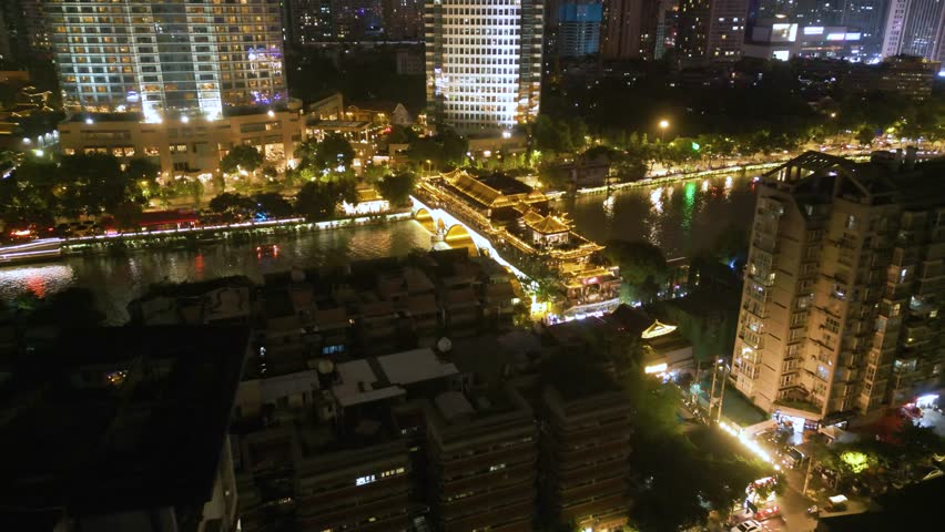Aerial view of flying over famous Anshun bridge and Fuhe river at night view with beautiful lighting in the center of Chengdu, China