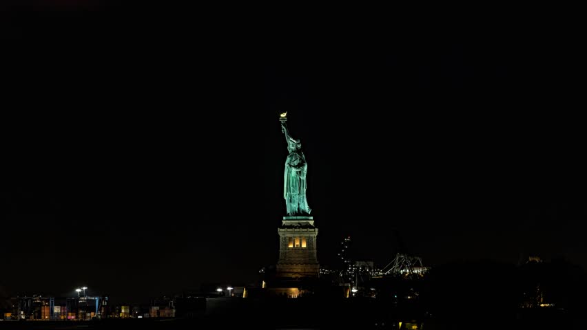 23.4 percent waxing crescent moon sets behind Statue of Liberty in New York City Royalty-Free Stock Footage #1109379009