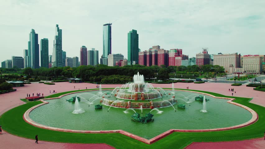 Incredible aerial of Chicago skyline with Buckingham Memorial Fountain. Beautiful aerial flying backwards above Grant Park. Room for text above. Cinematic establishing opener. Midwest Illinois USA