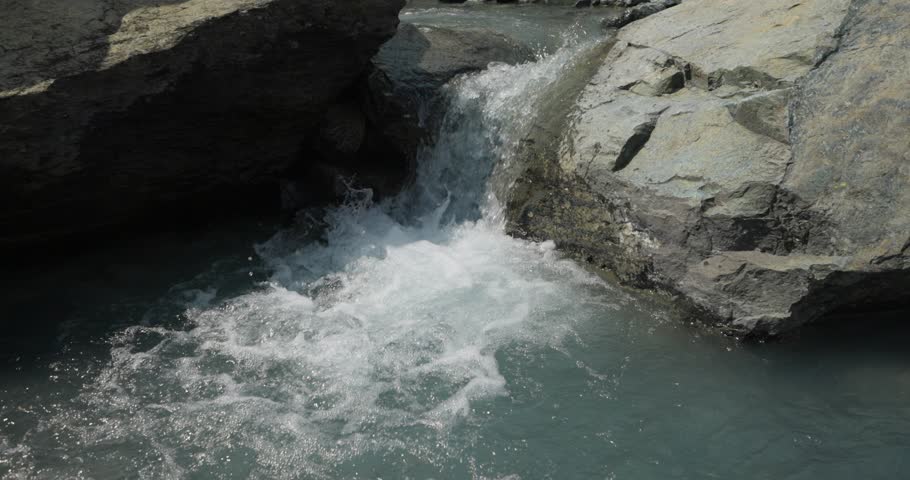 Water Flow Over Rock Forms Small Splashing Waterfall