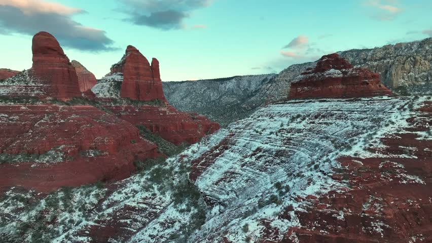 Snowy Hills Of Red Sandstone Rock Formations In Sedona, Arizona, USA. - aerial