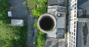 Summer aerial drone video of an abandoned industrial concrete smoke stack.	