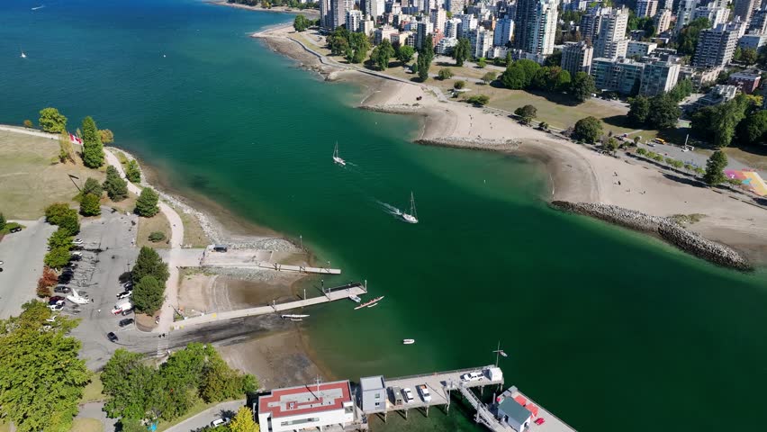 Sailboat Cruising In The False Creek Along The Sunset Beach In West End, Vancouver, BC, Canada. - aerial