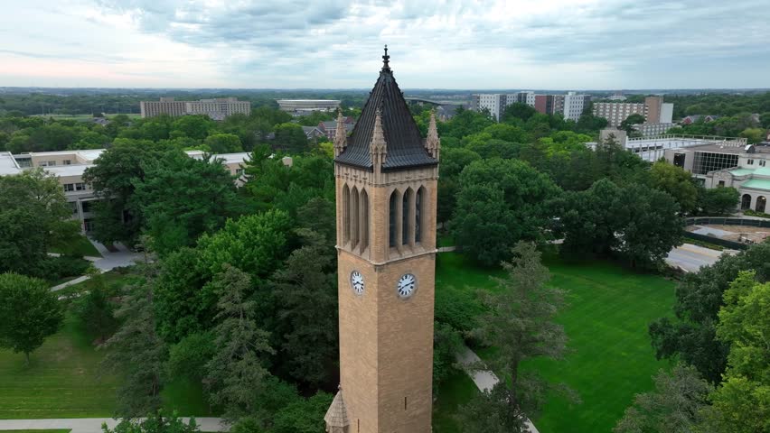 The Campanile is a clock tower and bell tower at Iowa State University. Aerial orbit on summer day.