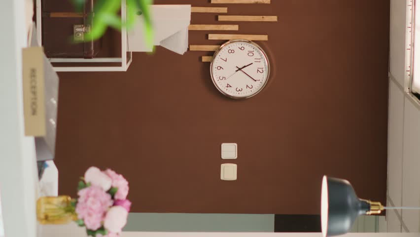 Vertical video Empty stylish hotel lounge area with expensive decorations, cozy furniture and equipped front desk ready to welcome guests. Travel accommodation five star resort with check in reception