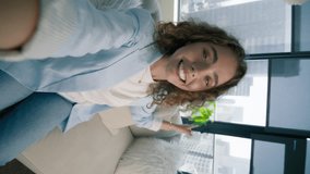 Vertical selfie close up face of young smiling woman 20s taking selfie showing new modern apartment. Beautiful girl creating trendy social media content on mobile app to share in blog 4K RED camera - Powered by Shutterstock - Get 15% off with code: PIKWIZARD15