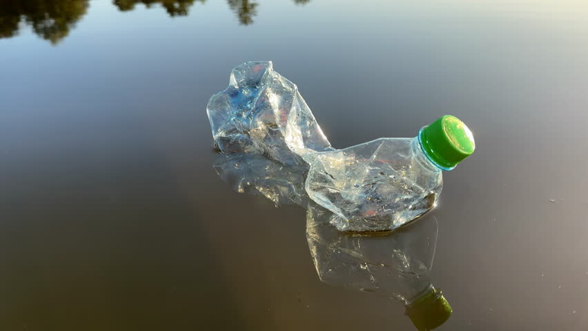 Marine plastic pollution from human activities at coastlines. Plastic waste in lake. Microplastics in groundwater. Ocean pollution and marine debris. Litter such as plastic from food in water of river | Shutterstock HD Video #1109399061