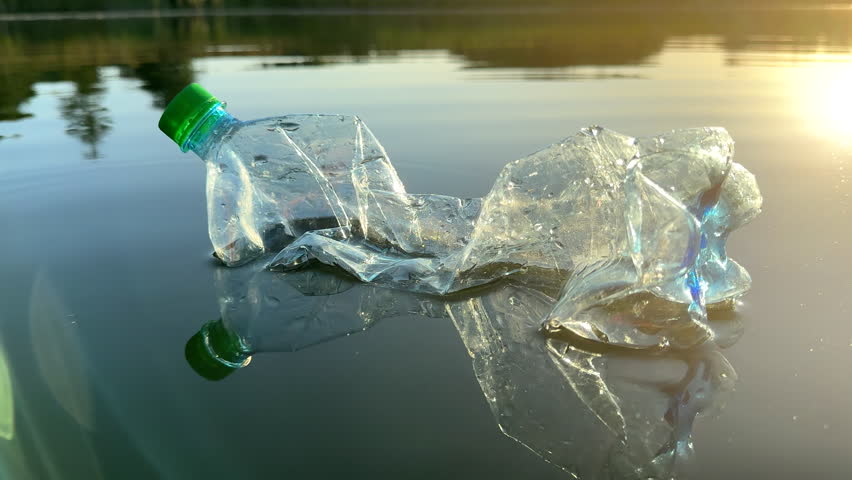 Marine plastic pollution from human activities at coastlines. Plastic waste in lake. Microplastics in groundwater. Ocean pollution and marine debris. Litter such as plastic from food in water of river | Shutterstock HD Video #1109399087