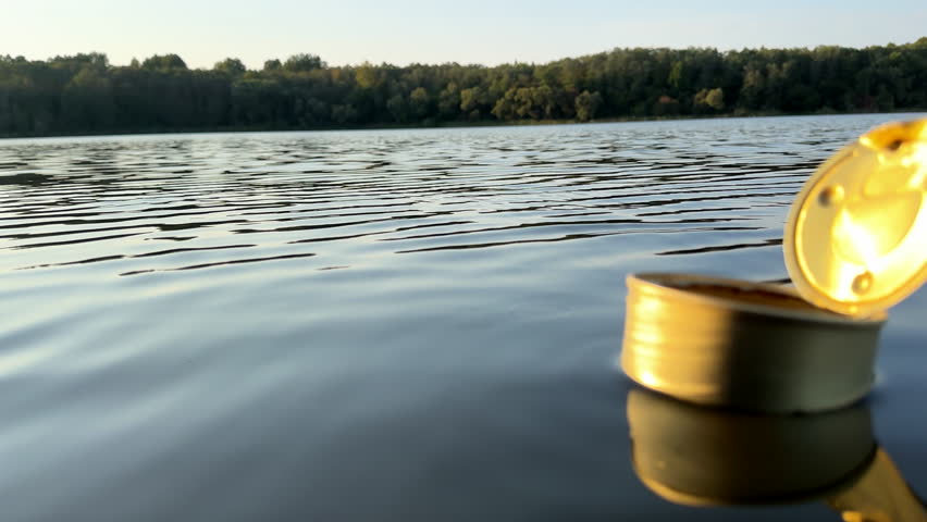 Tin can waste in lake water. Empty metal tin can garbage and food waste in ocean. Aquatic trash and Marine pollution. Steel tin cans to Recycling. Aluminum food tin can Waste, cans as garbage, litter | Shutterstock HD Video #1109399131