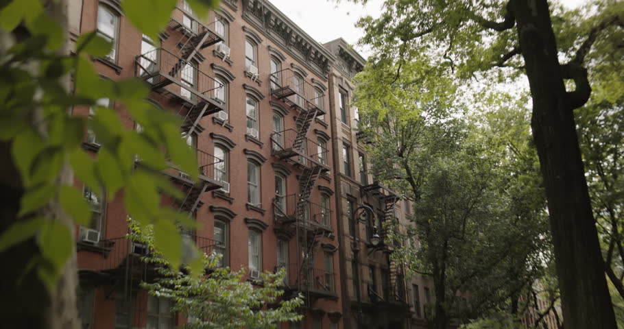 Establishing Shot with Old Renovated Brownstone House in New York City. Urban Architecture During Day Time of a Brick Multi-Storey Apartment Building with Emergency Stairs and Air Conditioning Royalty-Free Stock Footage #1109402971