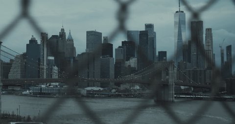Handheld Footage From Behind the Fence from Manhattan Bridge. New York City Cityscape in the Afternoon. Historic and Modern Skyscraper Buildings, Traffic on Brooklyn Bridgeの動画素材