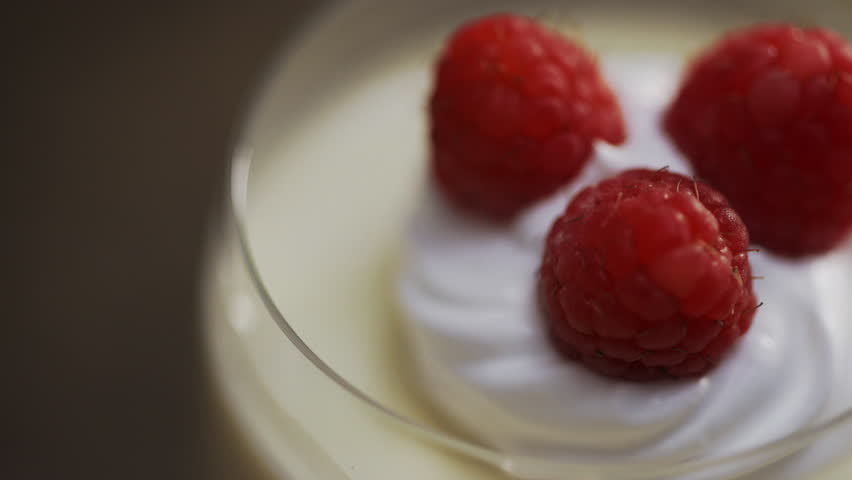 Chef places Raspberries to Cream