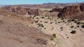 Scenic aerial landscape of a dry riverbed and mountain wilderness of northern Namibia