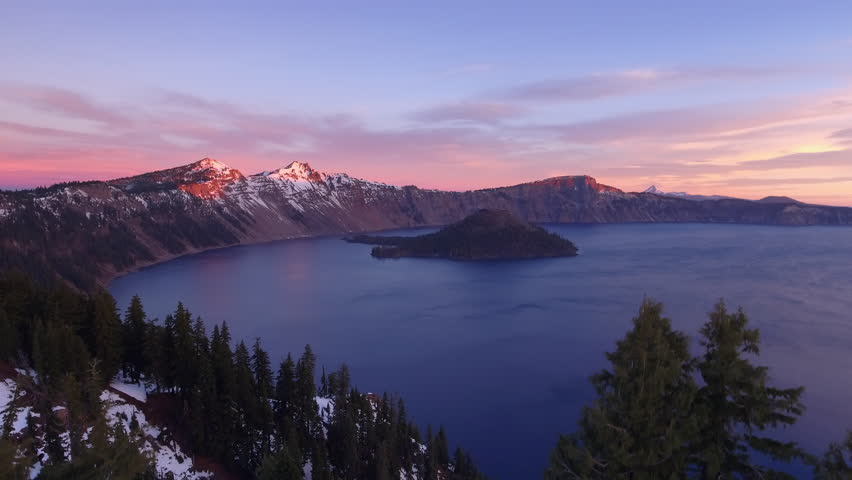 Slow Motion Shot Of Wizard Island In Crater Lake Near Mountain Ranges Against Sky - Portland, Oregon