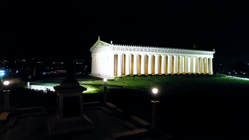 Aerial: Drone Flying Forward Towards Illuminated Famous The Parthenon In City Against Sky At Night - Nashville, Tennessee