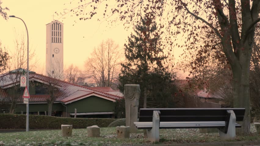 09.21.2023. Germany. Minden. Autumn. Autumn landscape. A bench and a chapel against the backdrop of autumn trees. First frost | Shutterstock HD Video #1109415123