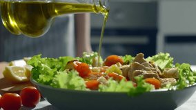 cooking homemade vegetable salad close up. olive oil pouring slow motion video. healthy mediterranean cuisine.organic food