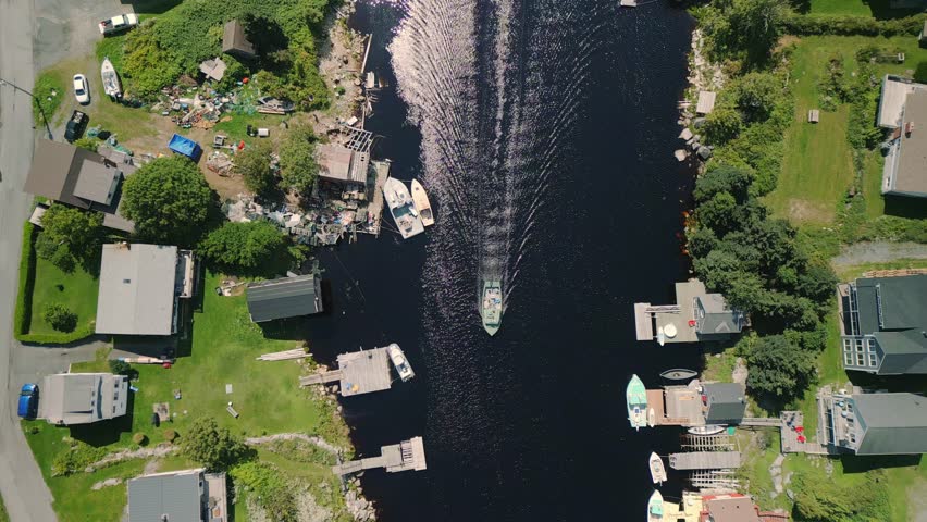 Top View, Fishing Motor Boat Sails into a Bay with a Port in a Small Village. Halifax, Canada. Leisure Activity, Sport and Recreation, Food Industry, Traditional Craft.