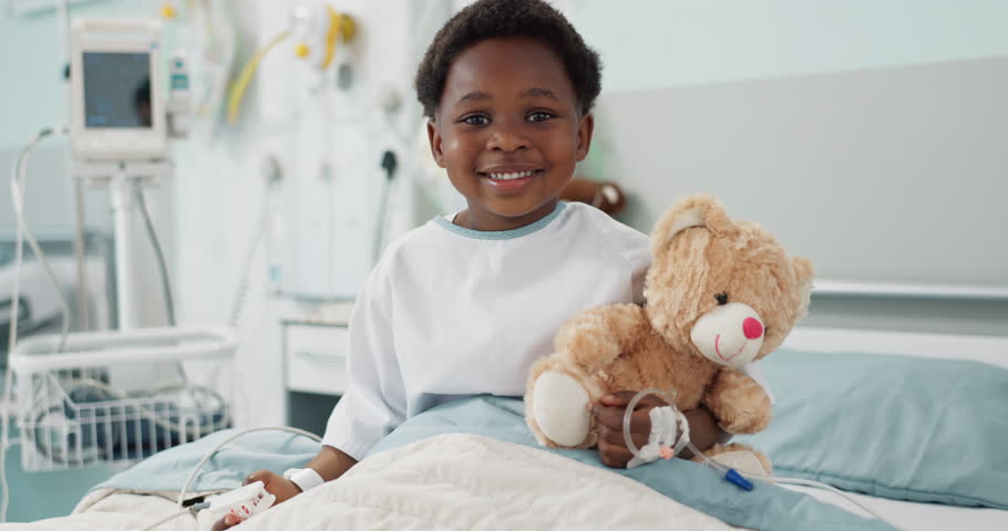 African boy kid, hospital and teddy bear on bed with face, smile or rest for recovery from surgery, treatment or health. Patient child, happy and portrait to relax, hug and clinic with care for toys Royalty-Free Stock Footage #1109431185