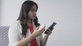 Asian woman video calling and consulting with doctor about taking medicine