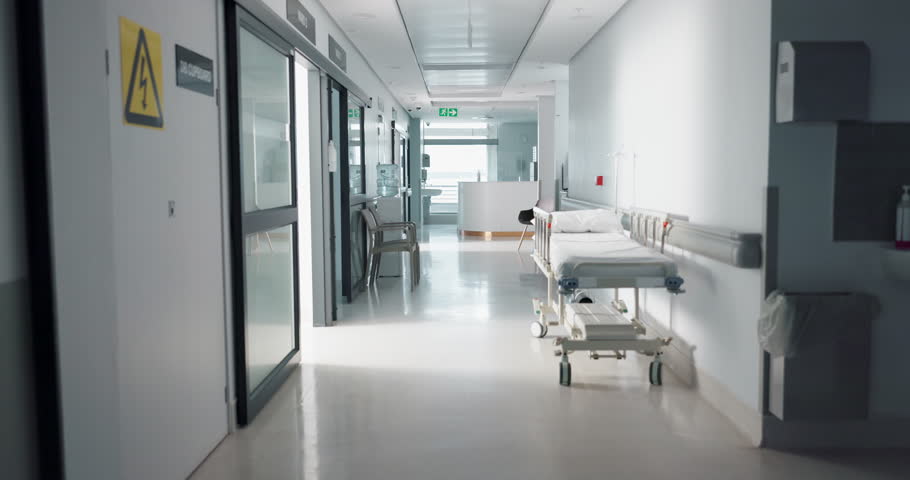 Healthcare, hospital and empty corridor with bed for medical care, health insurance and help in surgery. ER, emergency and lobby at clinic with stretcher for wellness, service and support in medicine Royalty-Free Stock Footage #1109434365