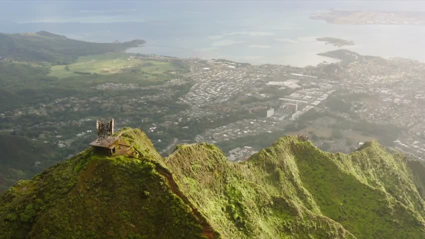 Aerial view on top of Haiku Stairs. Tourist attraction on Oahu island. Epic green mountain peaks with steep ridge, vertical incline 4K.Dramatic views of Stairway to Heaven hike on Oahu island, Hawaii