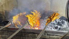 The chef at the barbecue restaurant uses charcoal fire to grill the whole chicken, charcoal grilled chicken