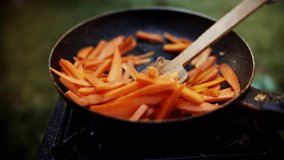 Fried Carrot In Pan. Vegetable Cooked In Hot Oil. Video Recipe. Cooking Vegan Food In Frying Pan. Chopped Red Carrot Fry In  Pan Summer Picnic. Carrot Frying In Olive Oil. Roasted Caramelized Carrots 