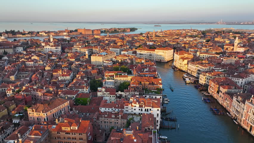Golden hour in Venice, aerial view of city skyline, Grand Canal with gondolas and boats, Venetian Lagoon, Italy Royalty-Free Stock Footage #1109444361