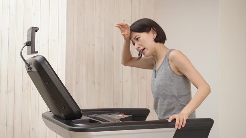 exhausted asian woman running on a treadmill in personal gym Royalty-Free Stock Footage #1109444563