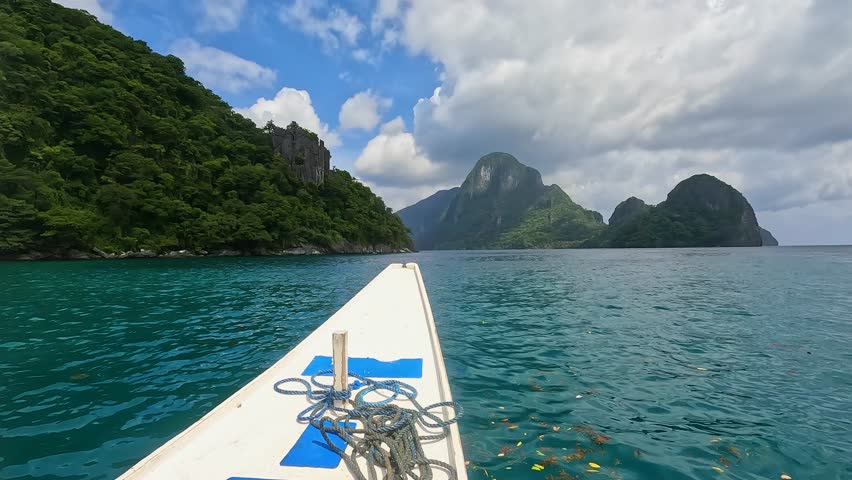 Traveling on boat approaching remote tropical islands on turquoise ocean water in El Nido, Palawan, Philippines, Southeast Asia Royalty-Free Stock Footage #1109444777