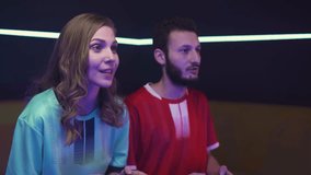Esports, young gamers plays a video game on a game console, the confrontation of two players, cybersportsman at a game tournament, the girl wins the game.