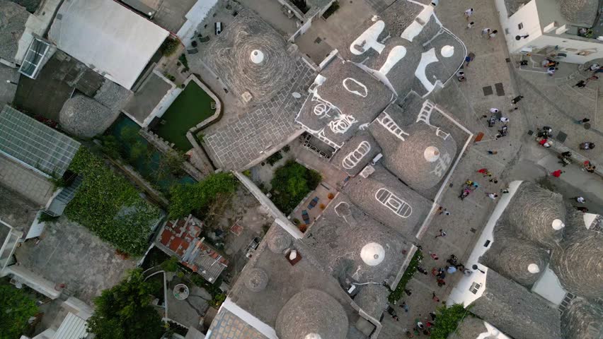 Tracking shot of the trulli of Alberobello city of Apulia, drone flies over old town buildings at sunset Royalty-Free Stock Footage #1109450795