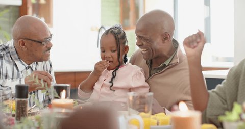 African american grandfather,father and granddaughter at thanksgiving dinner , slow motion. Thanksgiving, celebration, tradition, meal, home, family, togetherness and lifestyle, unaltered. स्टॉक वीडियो