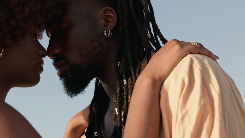 A closeup side profile shot of a black male and black female in love, noses touching, eyes closed, savoring their closeness Royalty-Free Stock Footage #1109459561