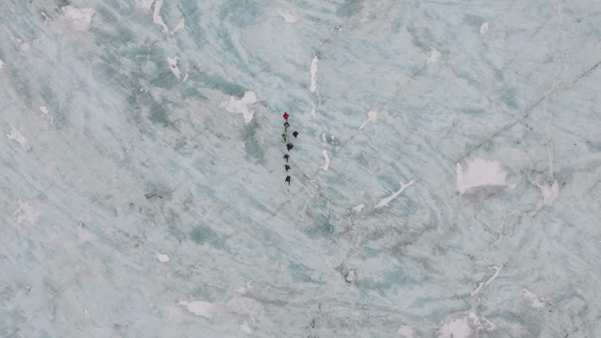 Aerial top view over people hiking on the ice surface of Virkisjokull glacier, Iceland