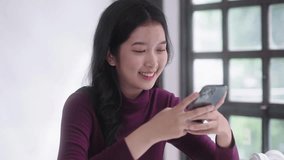 Young Asian student women using smartphone device gadget app or watching videos or  typing message chatting on social media, technology connection concept