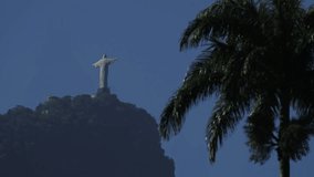 Distant View of Christ the Redeemer with Helicopter and Foreground Palms in Rio