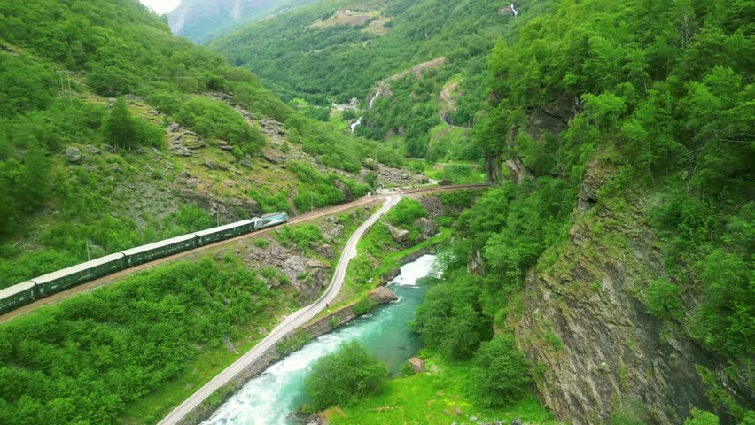 Aerial drone Norway landscape. Flamsbana train on Flam Railway. Mountains and waterfalls of Norway in summer. Famous train adventure for cruise ship tourists in Flam. 
 Royalty-Free Stock Footage #1109471223