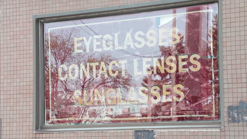 eyeglasses contact lenses sunglasses sign white red inside window writing caption text outside exterior Royalty-Free Stock Footage #1109471529