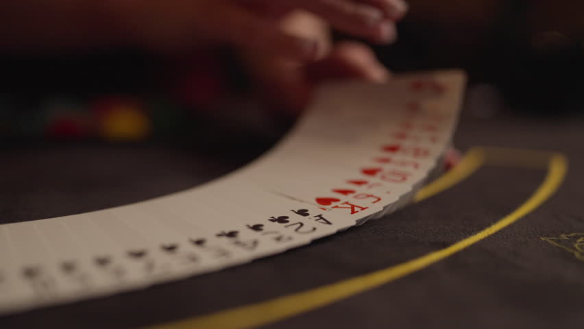 The dealer at the poker table turns over the cards. The beginning of the game, shuffling of cards Royalty-Free Stock Footage #1109473345