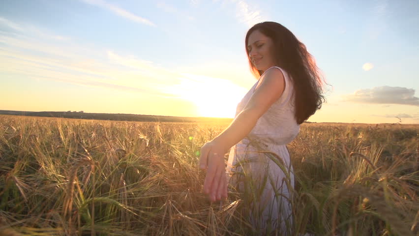 Beautiful Girl in a wheat field, touches the ears of wheat, the camera provides a view of beautiful landscape view,slow motion 240 | Shutterstock HD Video #11094755