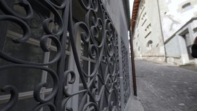Iron metal barrier to protect windows from intruders in private property by street with people walking in background. Traditional metal beautiful gate - Powered by Shutterstock - Get 15% off with code: PIKWIZARD15