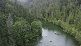 Scenic drone footage of Lacul Rosu, Romania. Fascinating aerial views of landscape, mountains and lake.