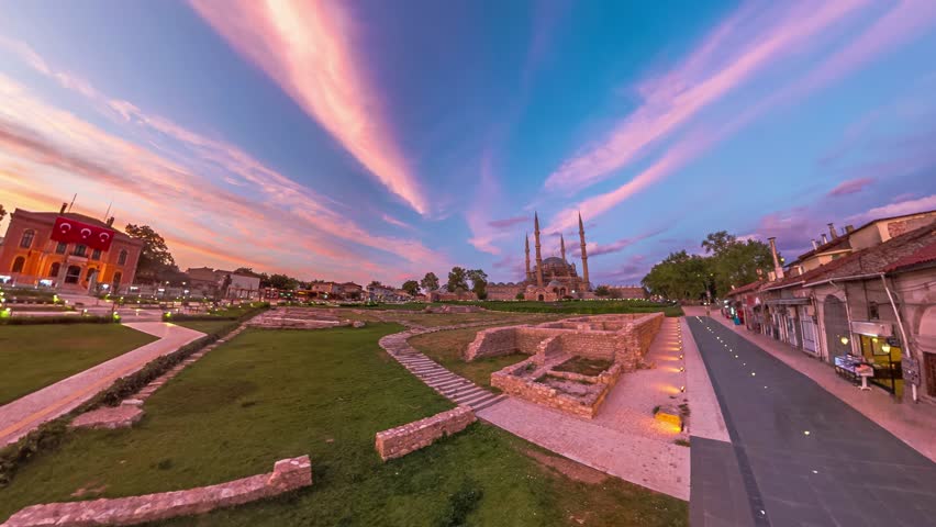 Edirne, Turkey evening with stunning cityscape. Eski Ulu Old Mosque and Selimiye Mosqueare in sunset golden hues, framed by graceful presence of Architect Sinan statue and Edirne Municipality building