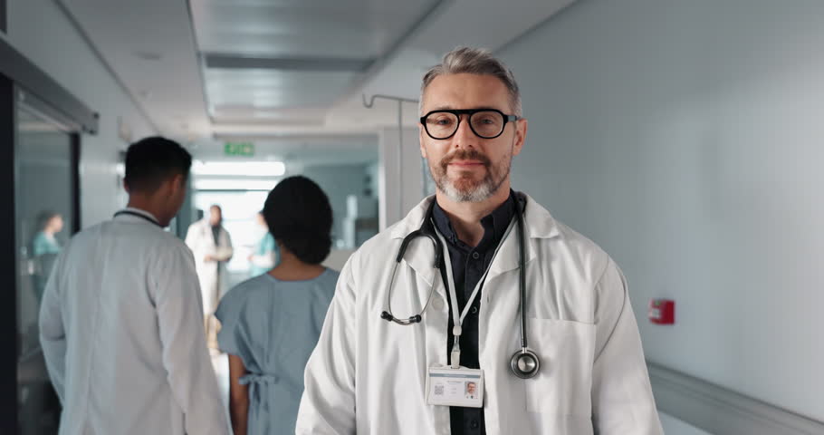 Doctor in portrait, senior man with arms crossed and healthcare, smile with confidence at hospital with pride and help. Medical professional, trust and happy at clinic with expert and stethoscope Royalty-Free Stock Footage #1109480741