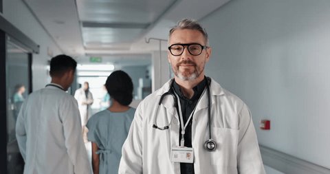 Doctor in portrait, senior man with arms crossed and healthcare, smile with confidence at hospital with pride and help. Medical professional, trust and happy at clinic with expert and stethoscope Video de stock